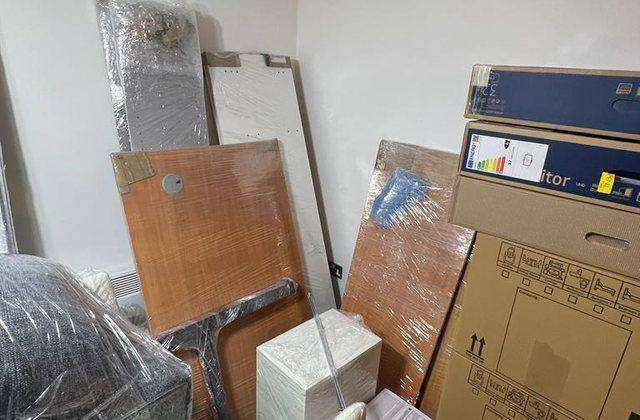 Wrapped furniture and packed items prepared for a professional house move